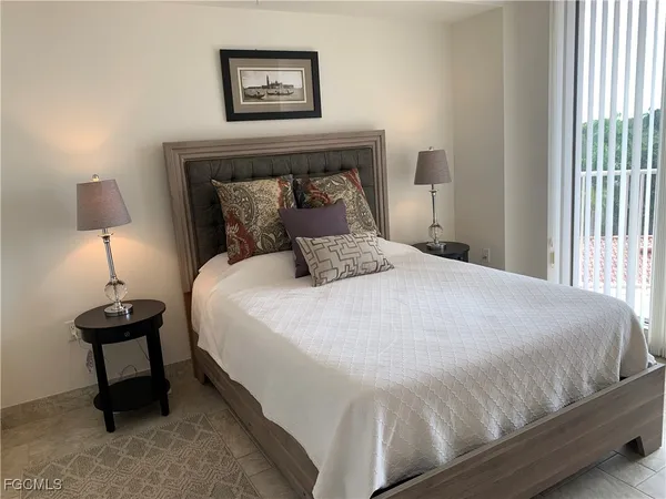 a bedroom with a bed and a night stand