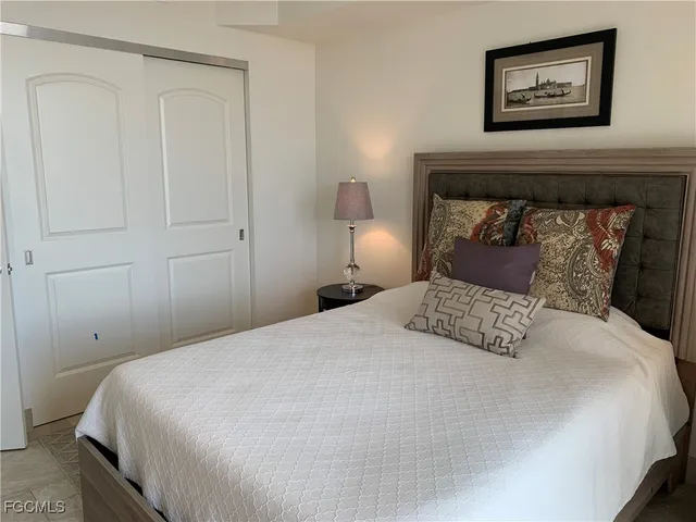 a bedroom with a bed and a painting on the wall