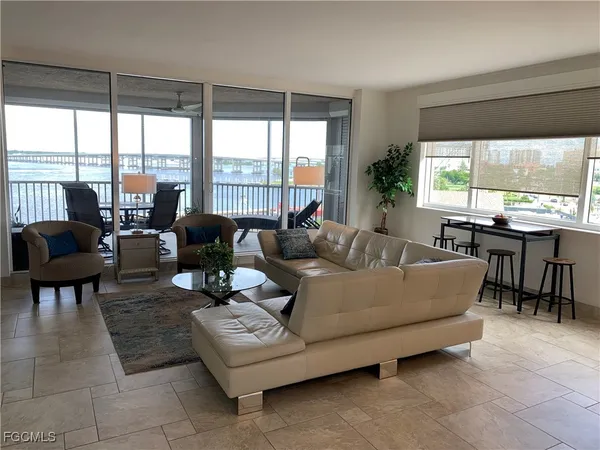 a living room with furniture and large windows