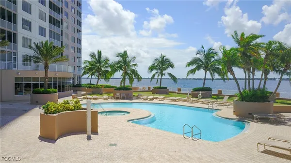 a view of swimming pool with outdoor seating and plants