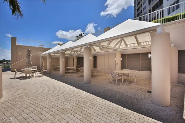 a view of a patio with table and chairs and potted plants