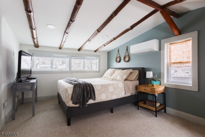 377 Lakeside Road West Milford, NJ 07421 - Photo 14 of 22 a bedroom with a bed and a chandelier