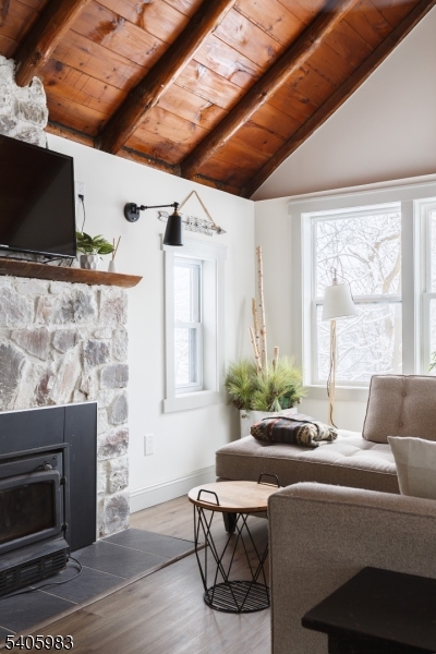 377 Lakeside Road West Milford, NJ 07421 - Photo 3 of 22 a living room with furniture a flat screen tv and a fireplace