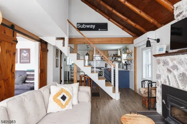 a living room with lots of furniture and wooden floor