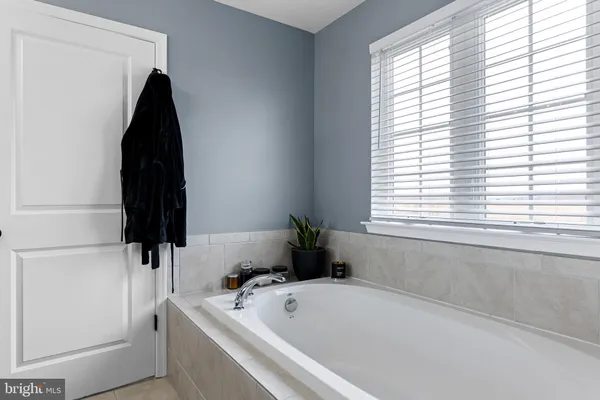 a bathroom with a bathtub and a window