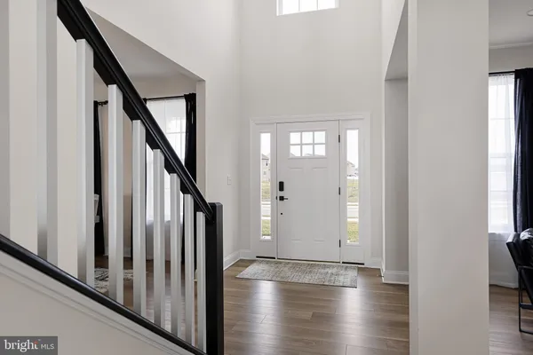 a view of an entryway with wooden floor and staircase