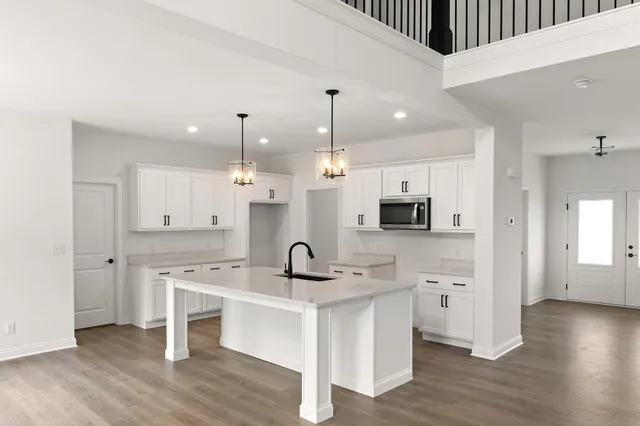 a kitchen with a sink cabinets and wooden floor