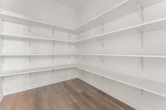 a view of walk in closet with empty racks
