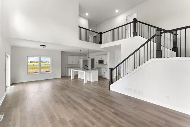 a view of staircase with wooden floor and a chandelier