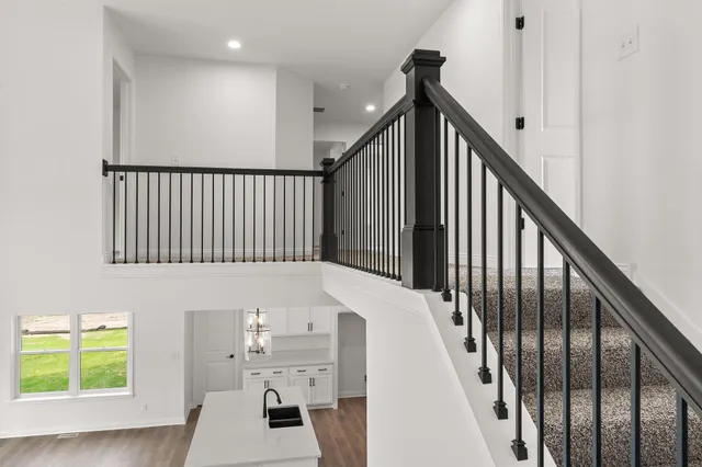 a view of entryway and hall with wooden floor