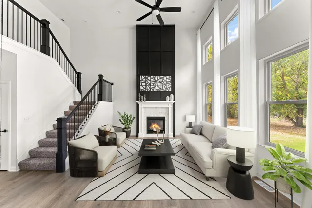 a living room with furniture fireplace and a large window