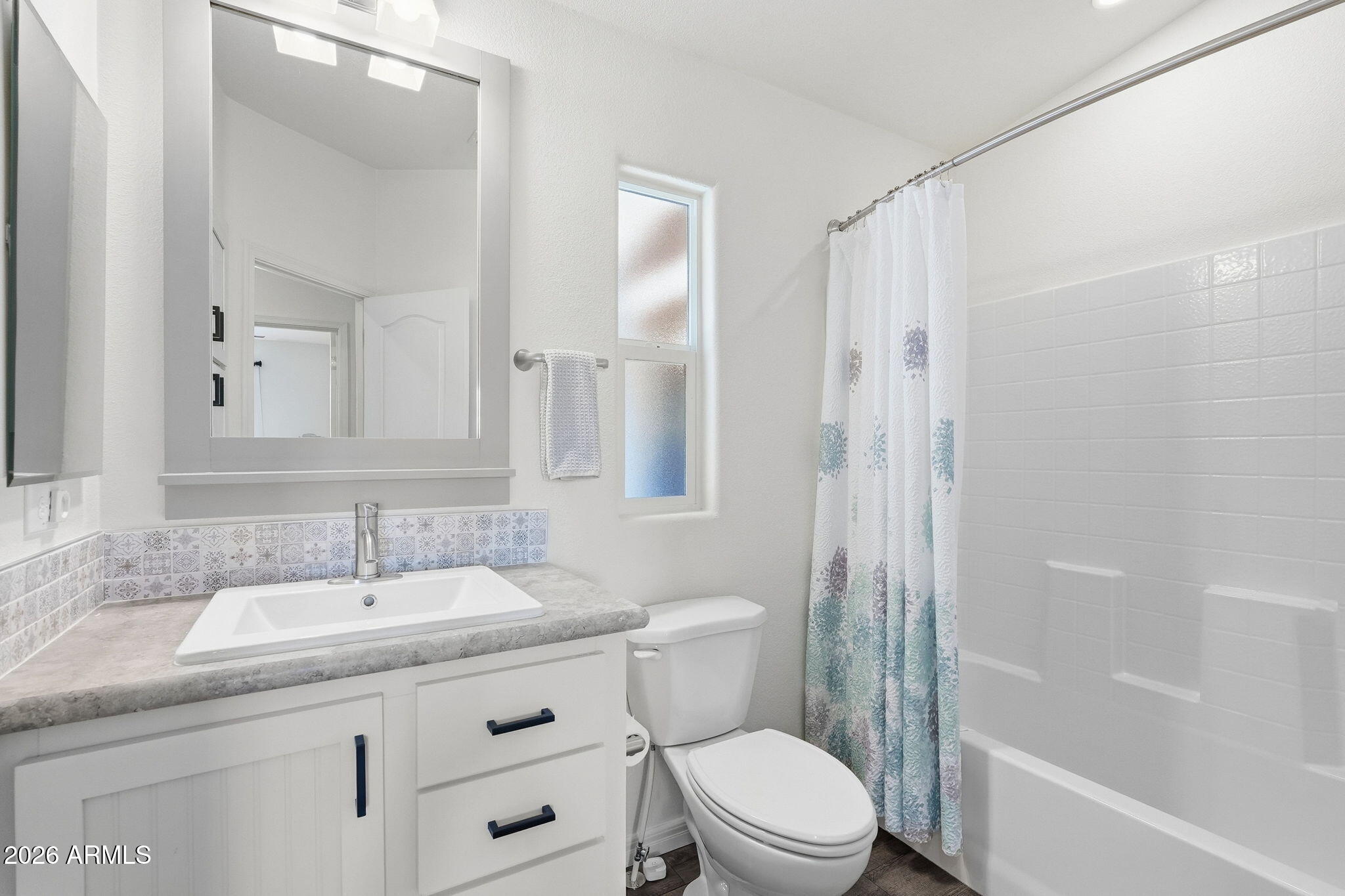 8865 East Baseline Road, Unit 74B Mesa, AZ 85209 - Photo 24 of 55 a bathroom with a granite countertop sink toilet a shower and a mirror