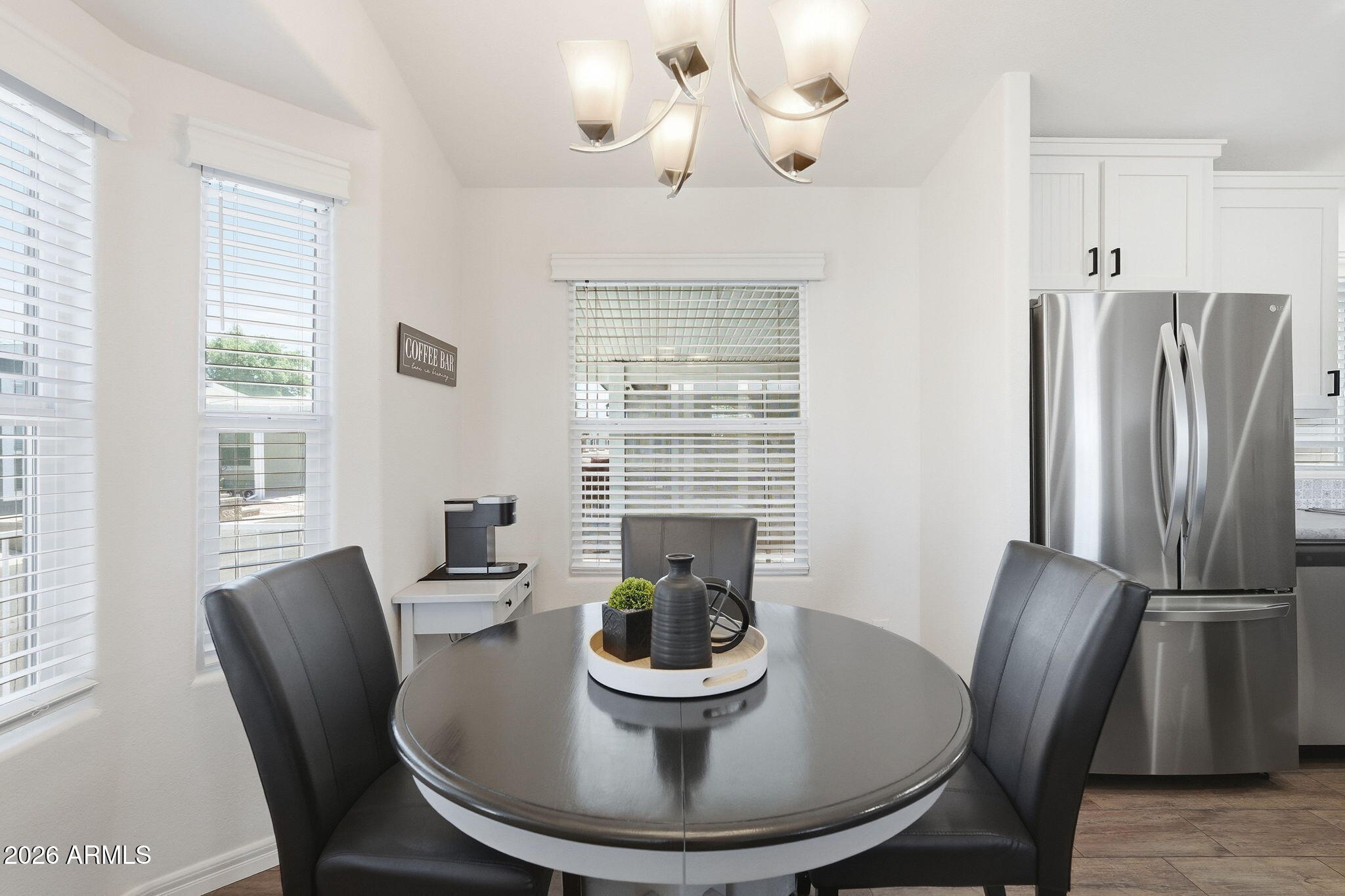 8865 East Baseline Road, Unit 74B Mesa, AZ 85209 - Photo 3 of 55 a dining room with furniture a window and wooden floor