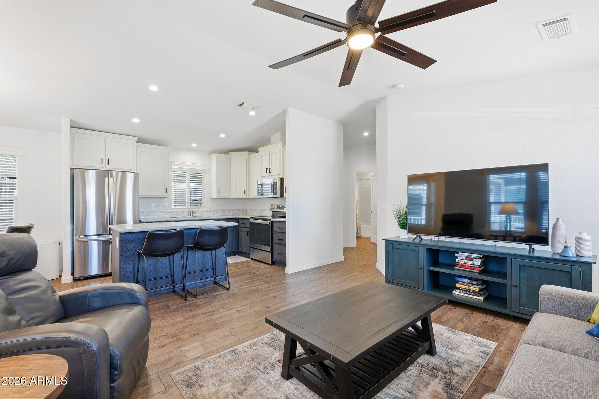 8865 East Baseline Road, Unit 74B Mesa, AZ 85209 - Photo 8 of 55 a living room with stainless steel appliances furniture and a flat screen tv
