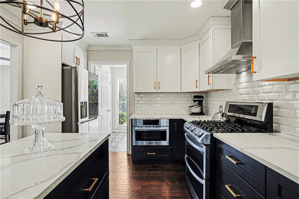 570 Morgan Court Hampton, GA 30228 - Photo 15 of 31 a kitchen with stainless steel appliances granite countertop a stove a sink and a refrigerator