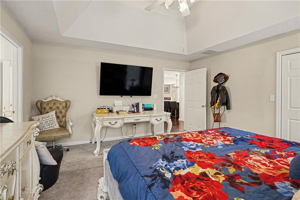 570 Morgan Court Hampton, GA 30228 - Photo 17 of 31 a bedroom with a bed and a flat screen tv