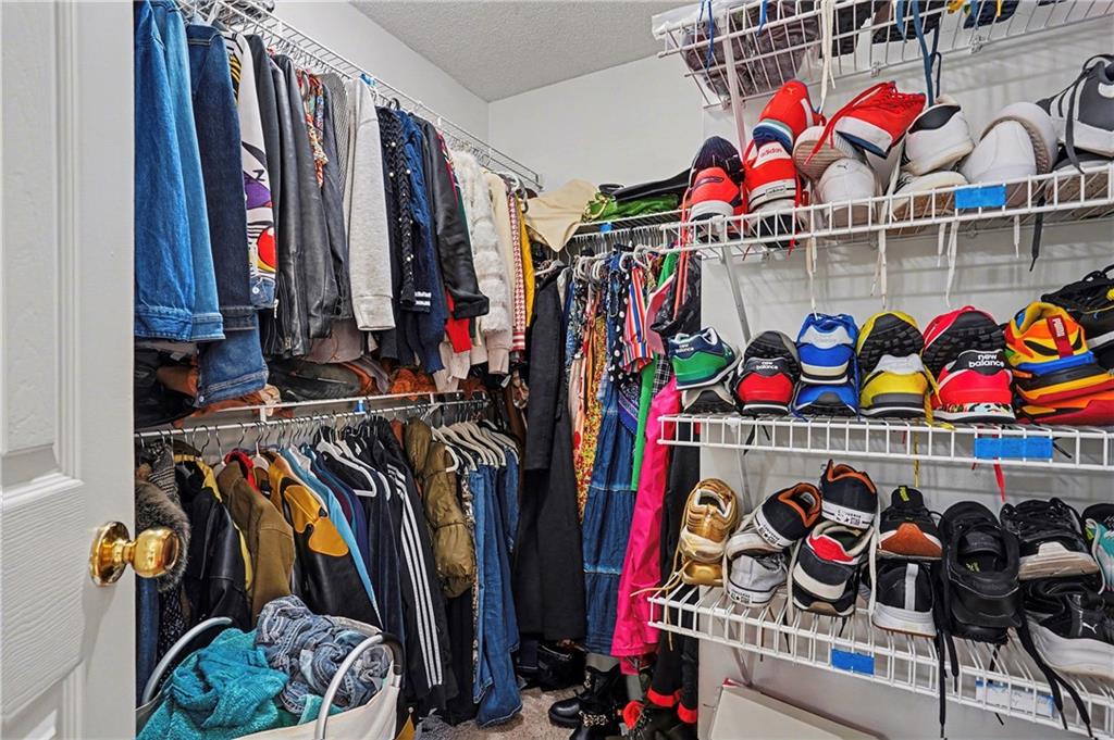 570 Morgan Court Hampton, GA 30228 - Photo 19 of 31 a view of walk in closet with clothes