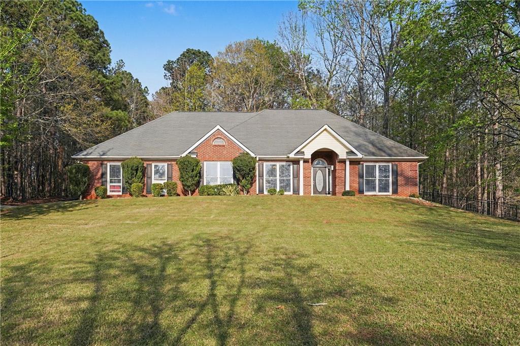 570 Morgan Court Hampton, GA 30228 - Photo 2 of 31 a view of a house with a garden