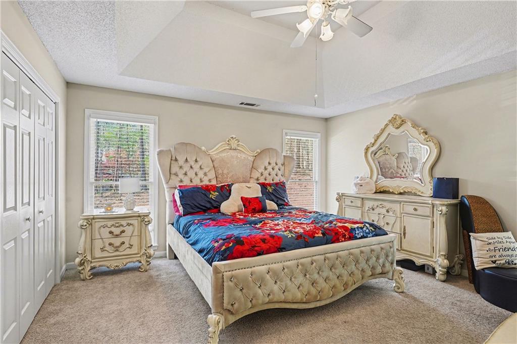 570 Morgan Court Hampton, GA 30228 - Photo 21 of 31 a bedroom with a bed a chandelier and dresser