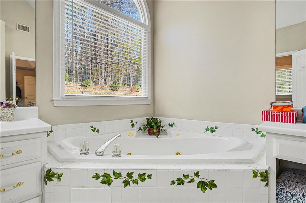 570 Morgan Court Hampton, GA 30228 - Photo 22 of 31 a bathroom with a bathtub and a sink