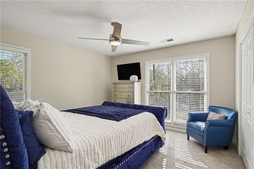 570 Morgan Court Hampton, GA 30228 - Photo 24 of 31 a bedroom with a large bed couch and a window