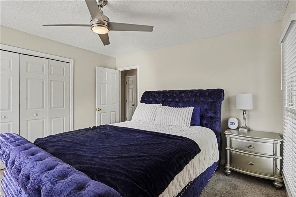 570 Morgan Court Hampton, GA 30228 - Photo 25 of 31 a bedroom with a bed and ceiling fan