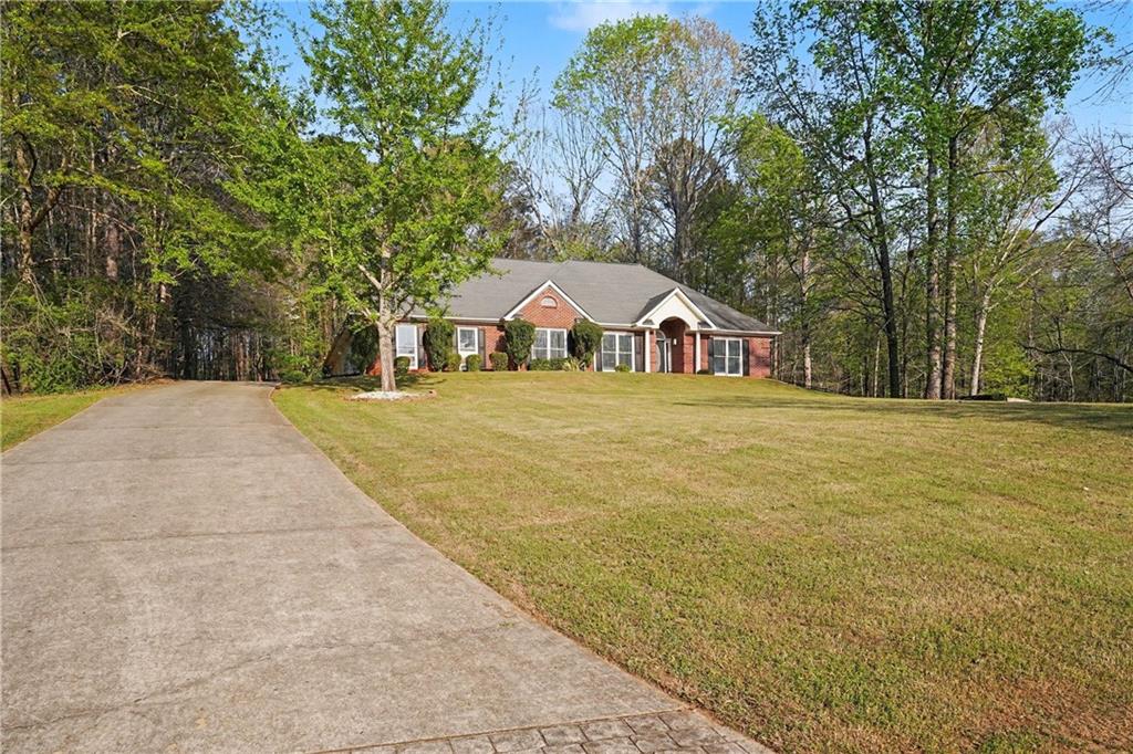 570 Morgan Court Hampton, GA 30228 - Photo 3 of 31 a house with trees in front of it