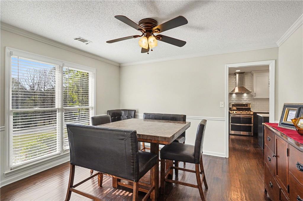 570 Morgan Court Hampton, GA 30228 - Photo 9 of 31 a view of a dining room with furniture window and wooden floor