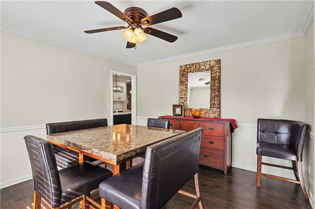 570 Morgan Court Hampton, GA 30228 - Photo 10 of 31 a room with a table chairs and wooden floor