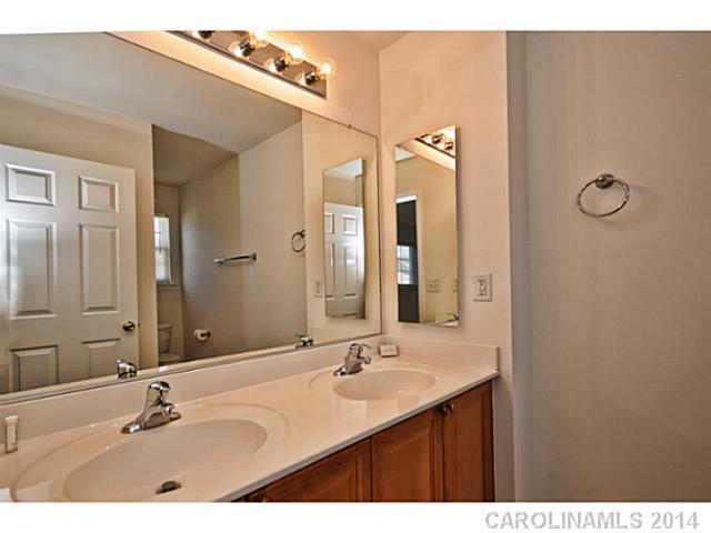 5028 Prosperity Ridge Road, Unit 5028 Charlotte, NC 28269 - Photo 11 of 16 a bathroom with a double vanity sink and a mirror