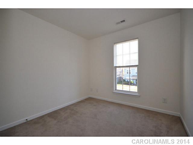 5028 Prosperity Ridge Road, Unit 5028 Charlotte, NC 28269 - Photo 13 of 16 a view of an empty room with a window