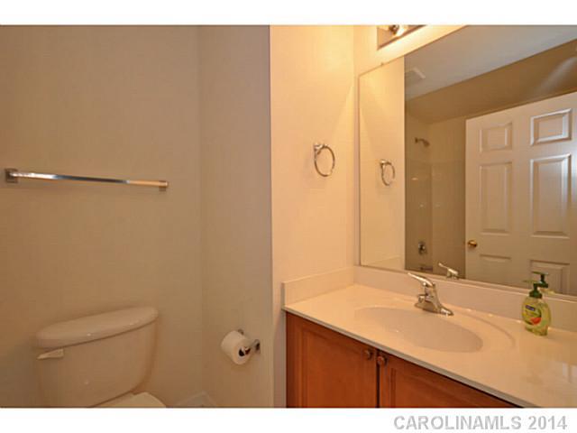 5028 Prosperity Ridge Road, Unit 5028 Charlotte, NC 28269 - Photo 14 of 16 a bathroom with a sink and a mirror