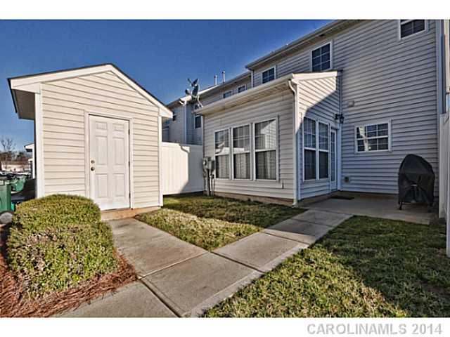 5028 Prosperity Ridge Road, Unit 5028 Charlotte, NC 28269 - Photo 16 of 16 a front view of a house with garden