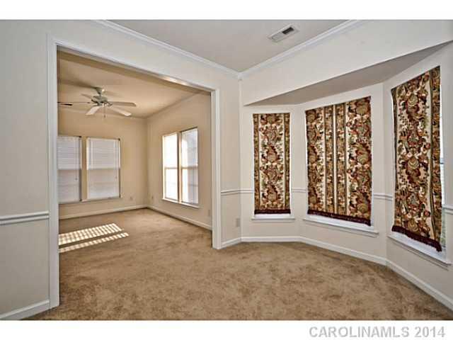 5028 Prosperity Ridge Road, Unit 5028 Charlotte, NC 28269 - Photo 4 of 16 a view of an empty room with floor to ceiling windows
