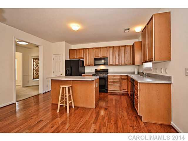 5028 Prosperity Ridge Road, Unit 5028 Charlotte, NC 28269 - Photo 6 of 16 a kitchen with stainless steel appliances granite countertop a stove a sink a refrigerator and a microwave