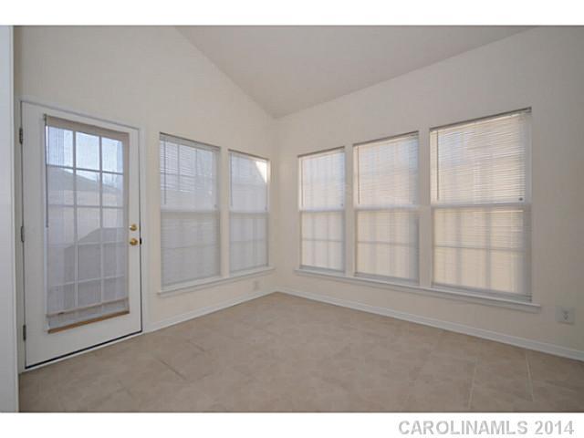5028 Prosperity Ridge Road, Unit 5028 Charlotte, NC 28269 - Photo 8 of 16 an empty room with cabinet and windows