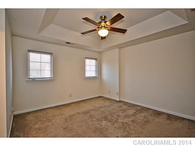 5028 Prosperity Ridge Road, Unit 5028 Charlotte, NC 28269 - Photo 10 of 16 a view of an empty room with a ceiling fan