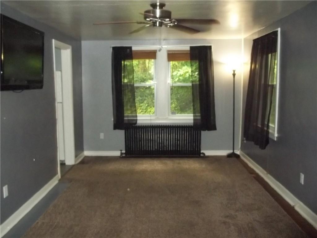 279 McCoy Road McKees Rocks, PA 15136 - Photo 3 of 32 a view of an empty room with a window and fireplace