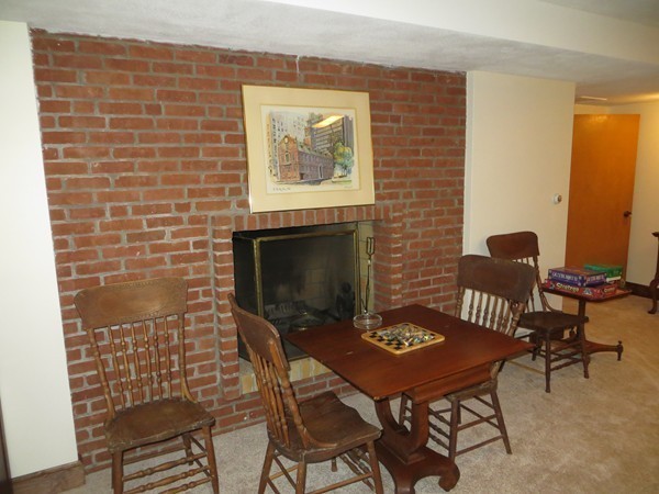 33 Woodfall Road Belmont, MA 02478 - Photo 16 of 22 a dining room with furniture and a fireplace