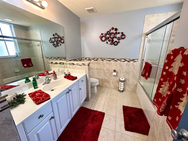 a bathroom with a sink mirror and toilet