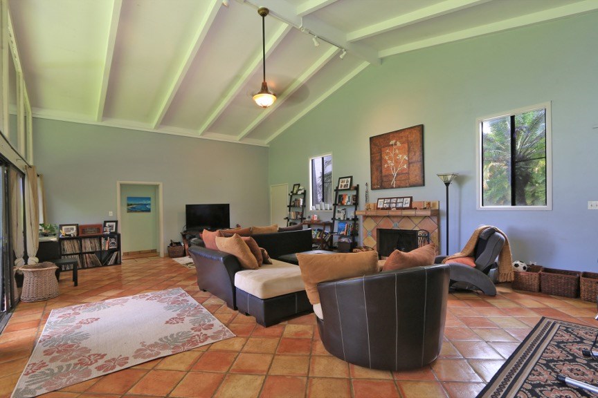 84 South Holokai Road Haiku, HI 96708 - Photo 4 of 17 a living room with furniture a fireplace and a flat screen tv