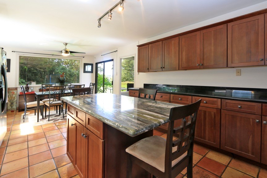 84 South Holokai Road Haiku, HI 96708 - Photo 8 of 17 a kitchen with a stove a table and chairs in it