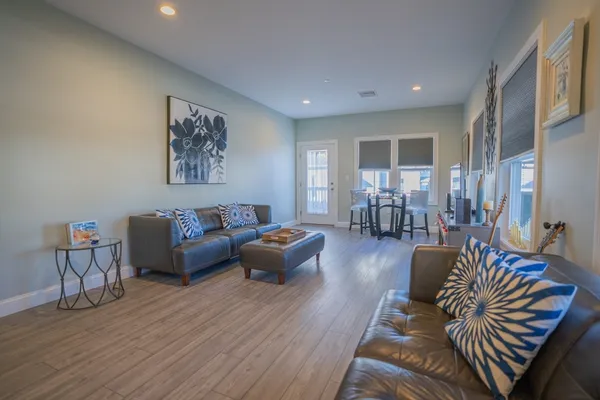 a living room with furniture and wooden floor