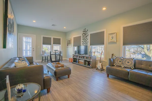 a living room with furniture and a wooden floor
