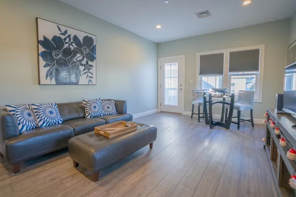 a living room with furniture and wooden floor