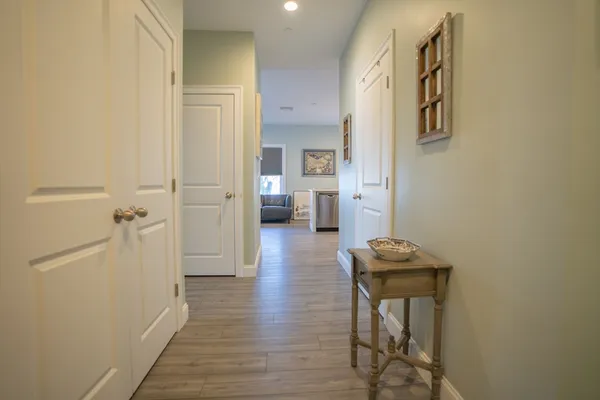 a view of hallway with wooden floor