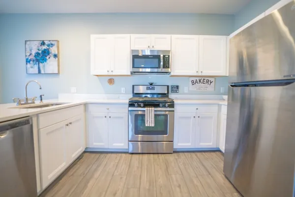 a kitchen with a stove cabinets and a refrigerator