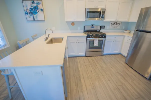 a kitchen with a refrigerator sink and stove