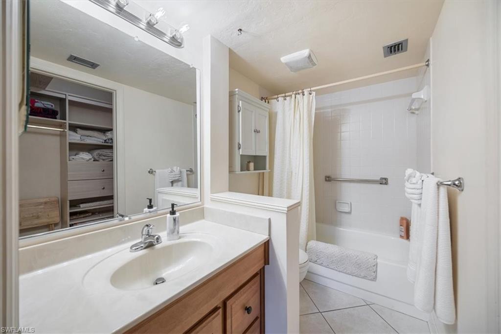 600 Neapolitan Way, Unit 115 Naples, FL 34103 - Photo 11 of 25 a bathroom with a sink toilet tub and shower