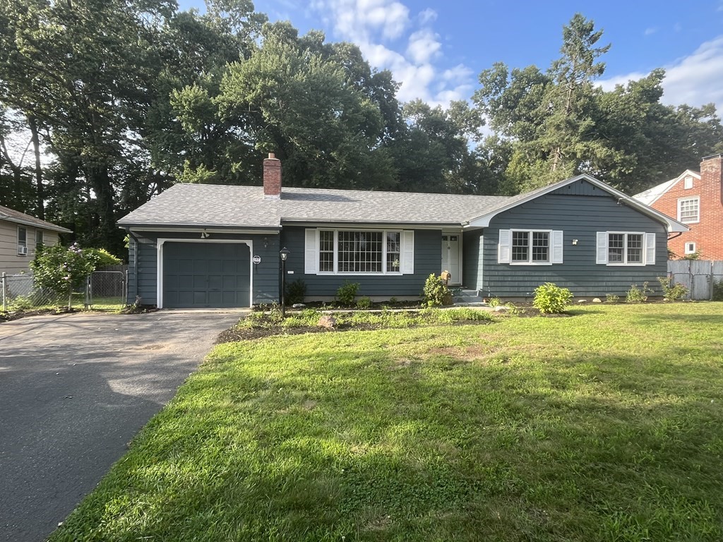 631 Allen Street Springfield, MA 01118 - Photo 1 of 15 a front view of a house with a yard outdoor seating and garage